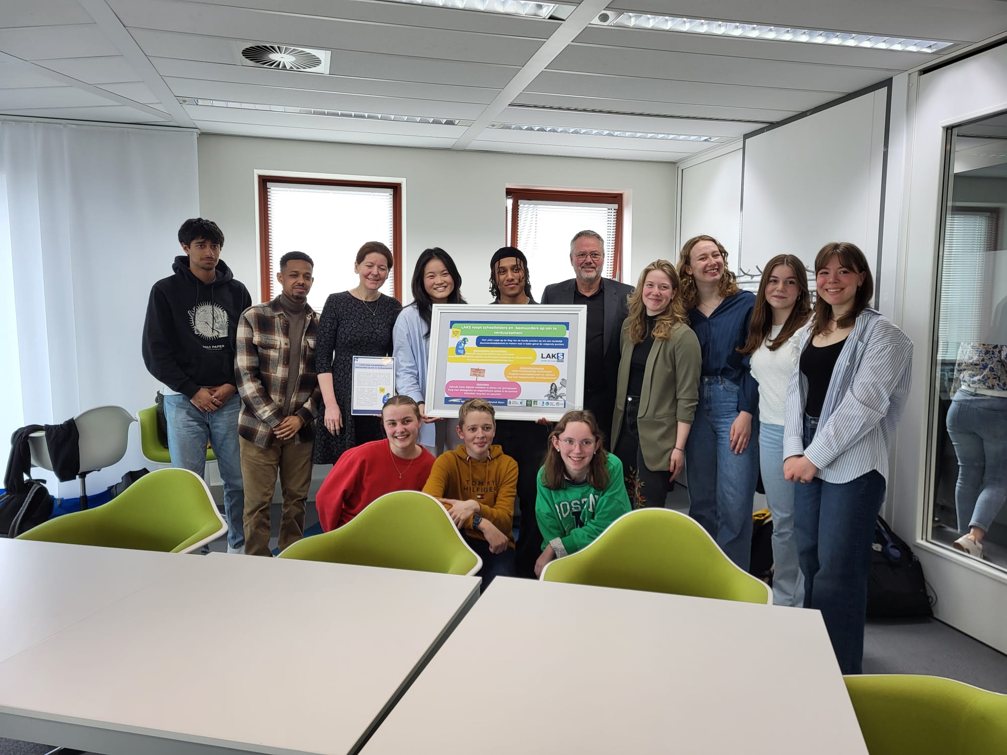Het LAKS-bestuur en leerlingen reiken het duurzaamheidsmanifest uit aan de voorzitters van de VO-raad.